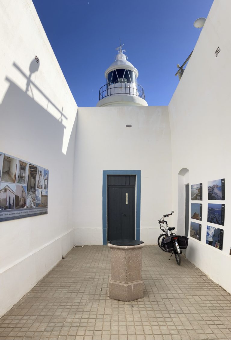 The bicycle of an employee is on the patio of a lighthouse converted into a museum, on the rocks near Albir.