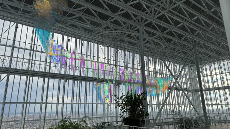 Hanging glass panels create a rainbow of colors in a modern building