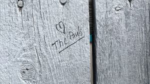 Wood plank boards with a heart and "The Pauls" carved into it.