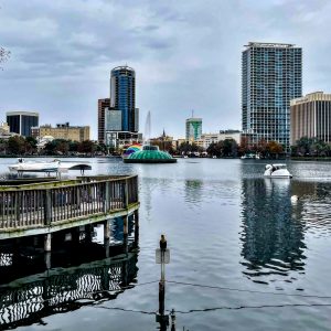 Lake Eola in downtown Orlando, showing part of the Orlando skyline, the Lake Eola fountain, a swanboat, and the rainbow ampitheater. 