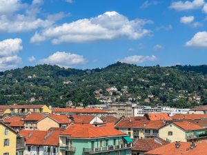 Mountains in the background over the colorful rooftops in Torino, Italy