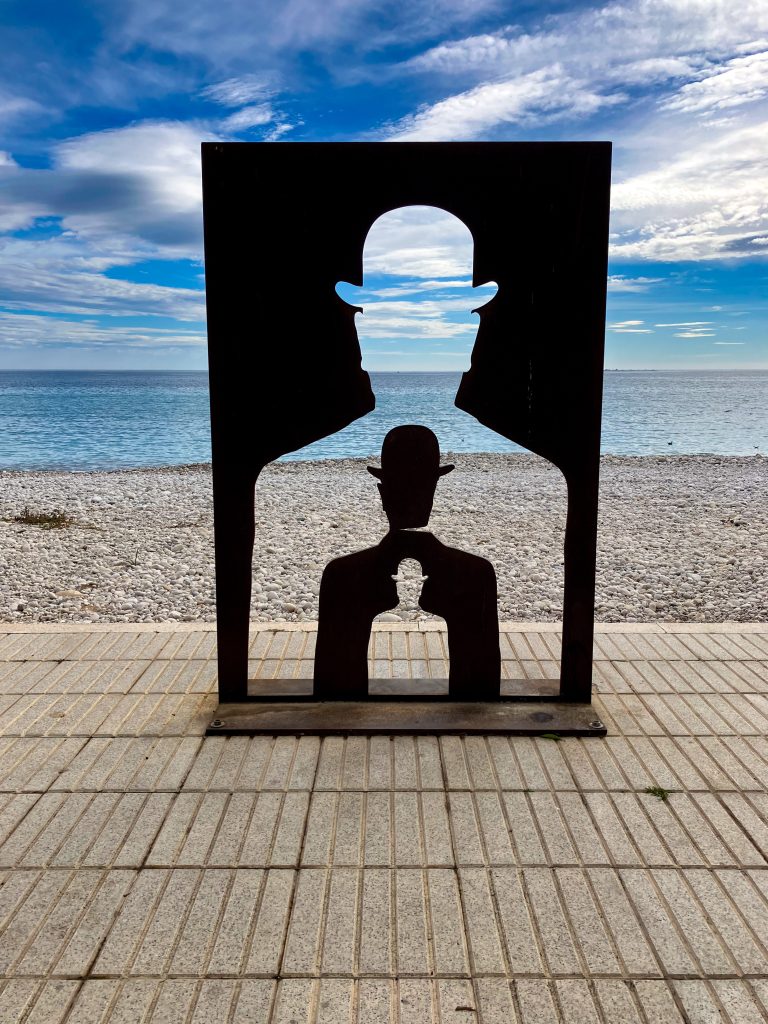 A glimpse of ‘Man with Bowler Hat’ towards the Mediterranean Sea in Altea, Spain.