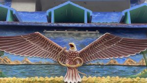 Colorful sculpture of an eagle with a snake in its talons