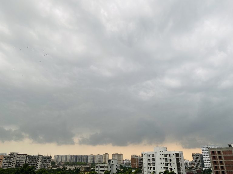 A dark sky over an urban skyline with highrise buildings