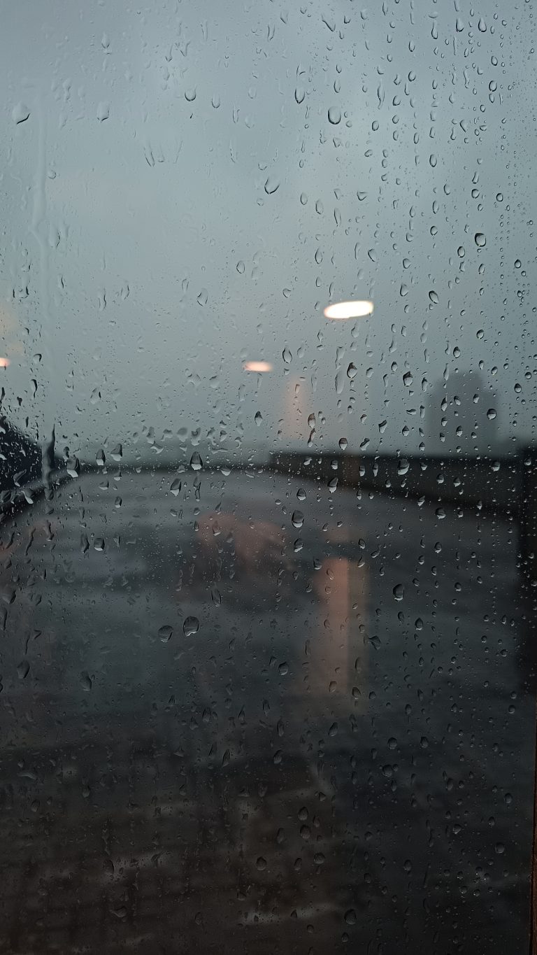 Raindrops on a glass window. Light shadow on the window