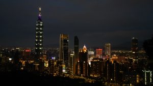 View larger photo: A view of Taipei city at night.  Taken from a high vantage point to the south of the city the night sky is illuminated by the city lights with the Taipei 101 skyscraper visible on the left hand side.