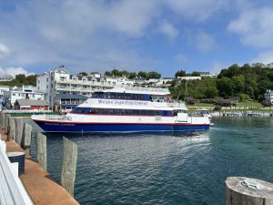 View larger photo: Mackinac Island ferry coming in to dock with the Pink Pony hotel behind it.