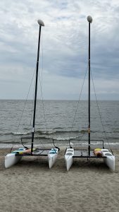  Two catamarans sitting on the beach with small bayside waves in the background (Lewes Public Beach, Delaware).
