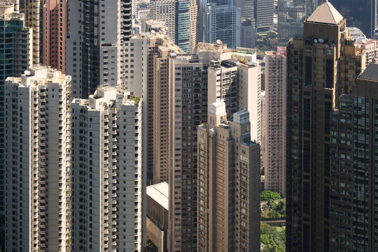 The frame is filled with tall, mostly, residential buildings. The tops of the foreground buildings are visible, but the ones further back fill the frame top to bottom.