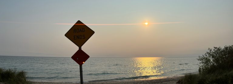 Street sign where the road ends and Lake Michigan begins that says Road Ends