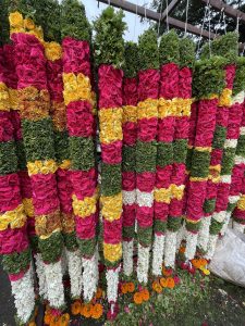 View larger photo: Long multiple colour garland created using various flowers and leaves. An early morning view from KR Market, Bengaluru, Karnataka.