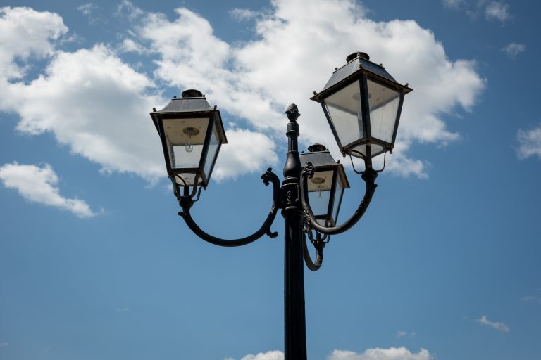 Ornamental street lights against a partially clouded blue sky. Seen in Nessebar, Bulgaria.