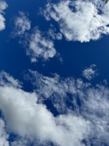 A deep blue sky with scattered white clouds.