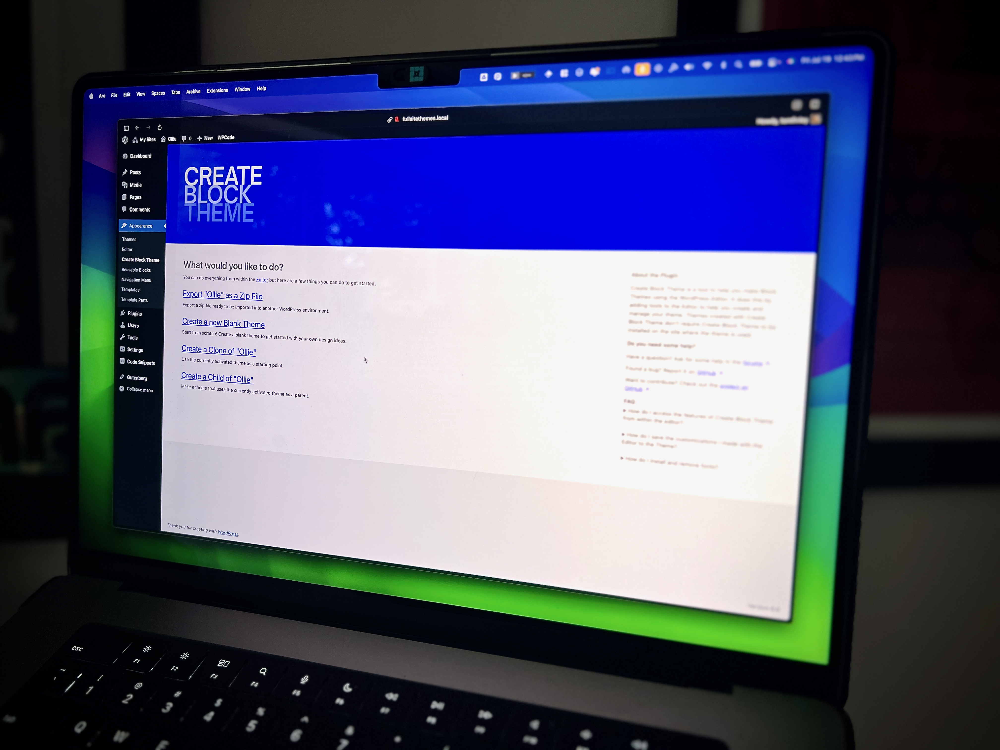 Photo of a Macbook Pro laptop positioned on a riser, with a simple browser displaying the WordPress.org Create Block Theme plugin splash screen.