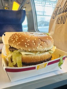  Close up view of a hamburger on the table of a speed train in Germany.
