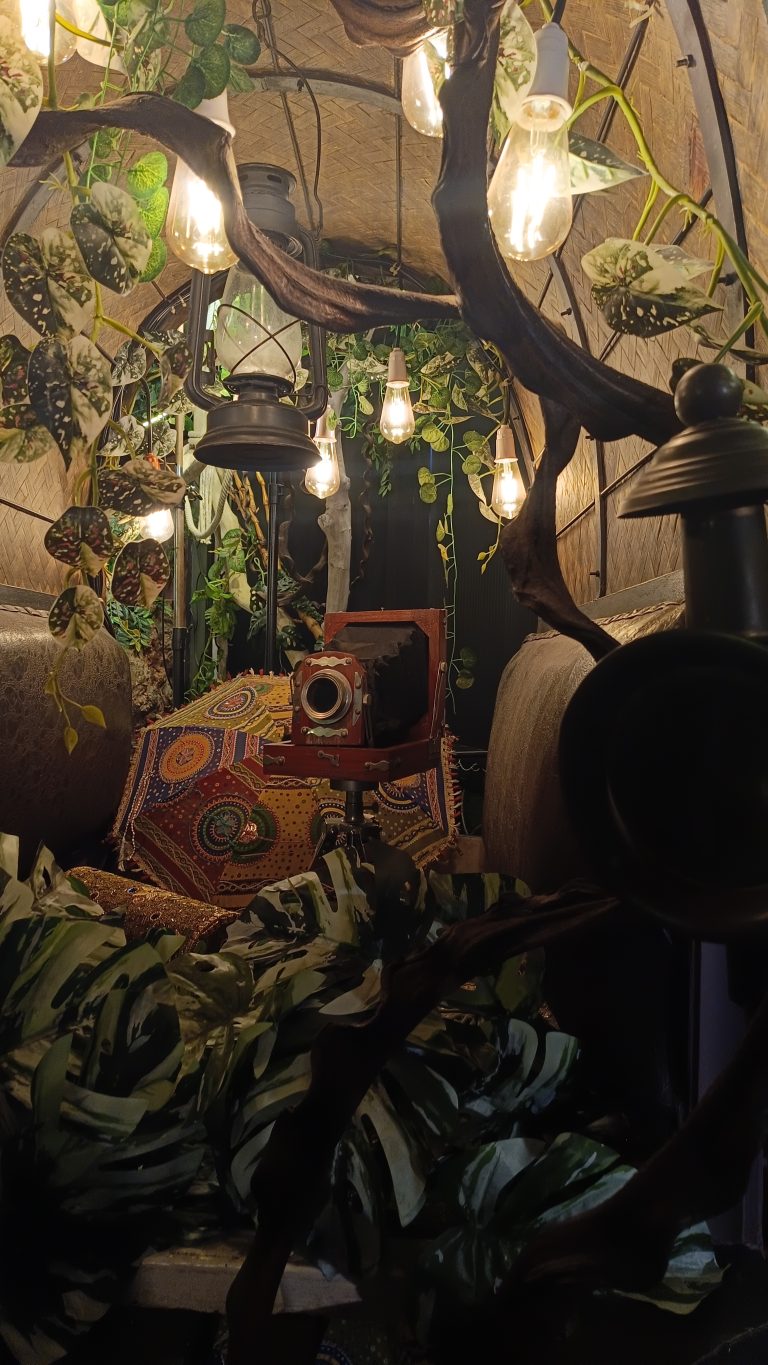 An old camera, lantern, umbrella and other light decorations.