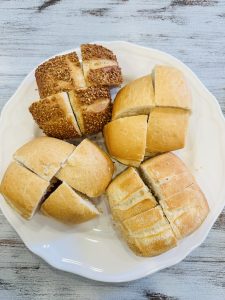 A plate full of bread pieces which was served in restaurant before the food arrived.