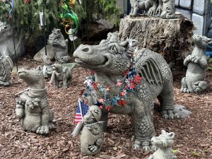 View larger photo: Red, White, and Blue garland decorating concrete dragons, with one holding a flag of the USA.