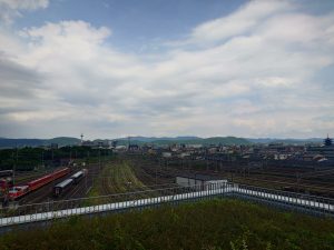 View larger photo: Railway yard view towards Kyoto's main railway station, mountains and blue sky in the background.