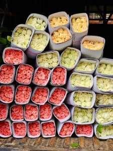 View larger photo: Different colours of roses are organised in paper boxes for sale. An early morning view from KR Market, Bengaluru, Karnataka.