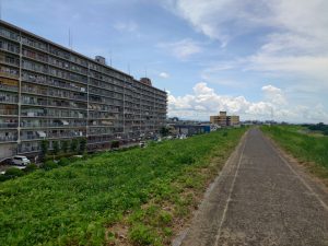 Japanese residential building alongside cycle path.