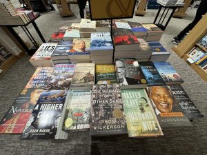 A table stacked with history books at a bookstore. 
