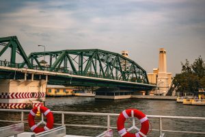 A green metal truss bridge of The Phra Phutthayotfa Bridge, Thailand. 