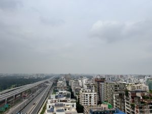 View larger photo: View of Dhaka, Bangladesh, taken from an elevated position. The express highway is visible on the left. The sky is cloudy and gray.