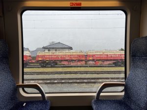  An industrial train as seen through another train window, in Vienna, Austria.