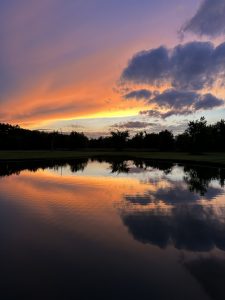 View larger photo: Vibrant sunset mirrored over a pond in New Douglas, Illinois