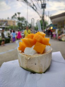 View larger photo: Ice cream and fresh mango chunks served in a coconut shell.