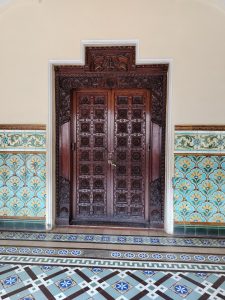 View larger photo: This is an internal door with intricate wood carving. This image was taken in the internal spaces of the Mysore Palace, India.