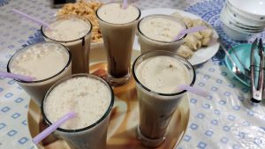  An assortment of drinks on a tray is displayed on a table, creating a welcoming atmosphere for socializing.
