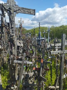 View larger photo: Hundreds of wooden and metal crosses on a hill. Sunny sky with few clouds. Photo taken at Hill of Crosses, Lithuania.