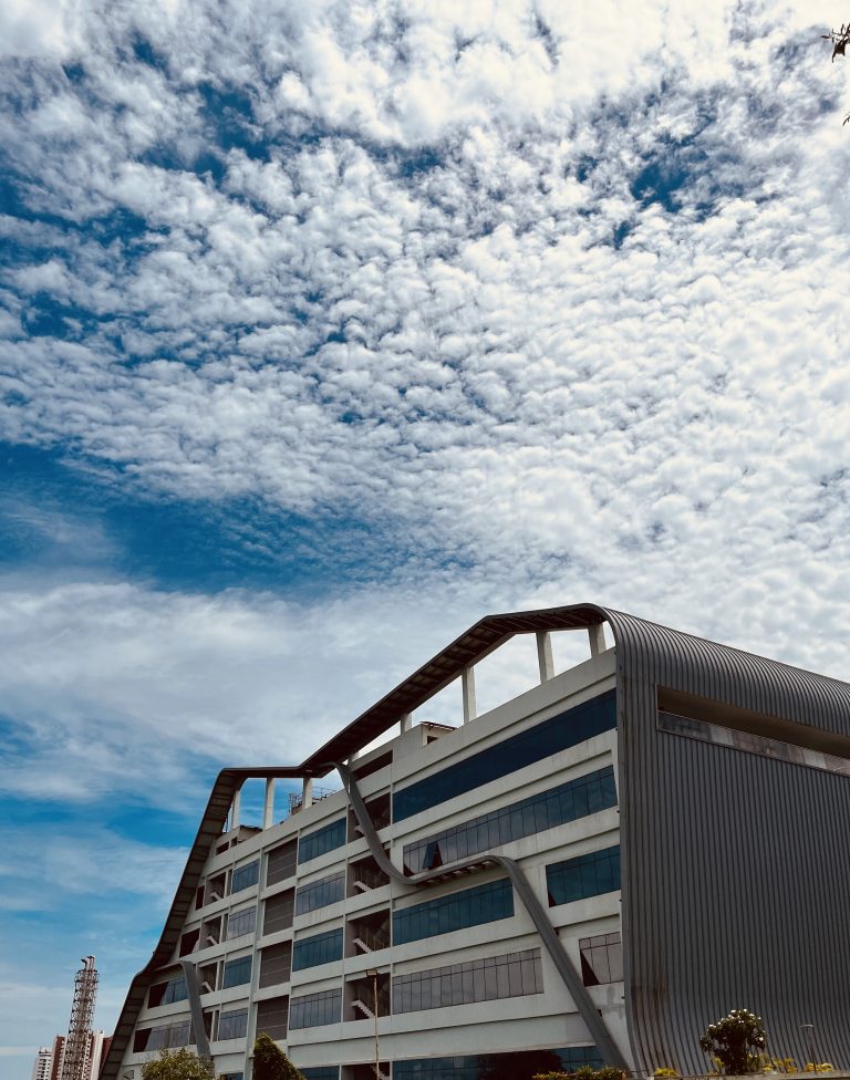 A cloudy sky above a modern building.