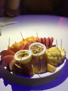 View larger photo: A fruit dish with passion fruit, apple, orange, pineapple and watermelon.