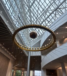 View larger photo: Oregon Convention Center Interior, the ceiling fixture is a kinetic sculpture with a swinging brass pendulum.