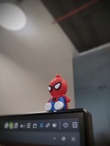 View larger photo: A spiderman action figure, on top of a computer monitor.