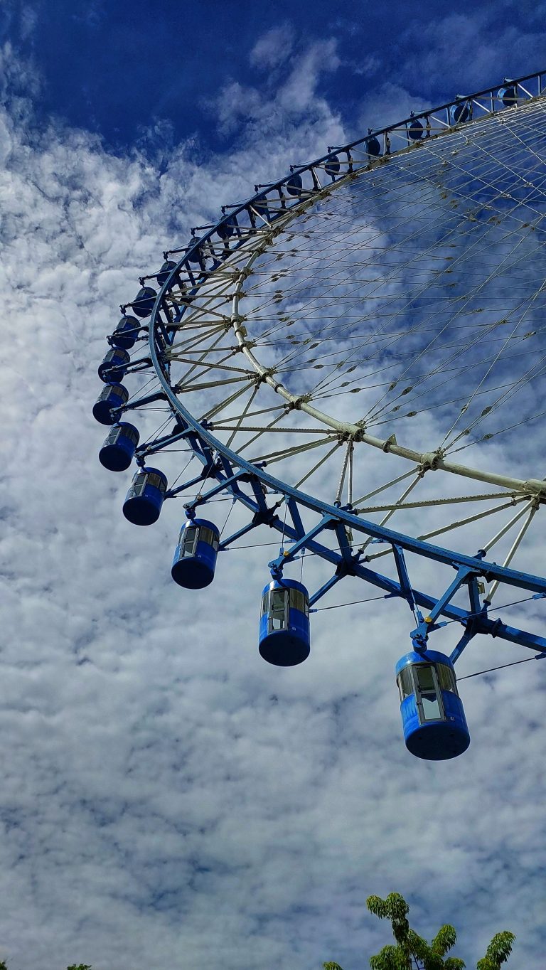 A part of ferris wheel with blue sky in background. The ferris wheel is called as Angkor Eye and it’s located in Krong Siem Reap, Cambodia.