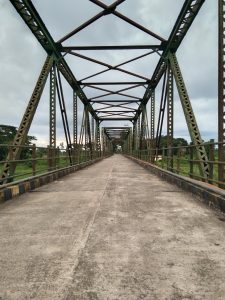 Bridge with concrete floor and steel girders above.