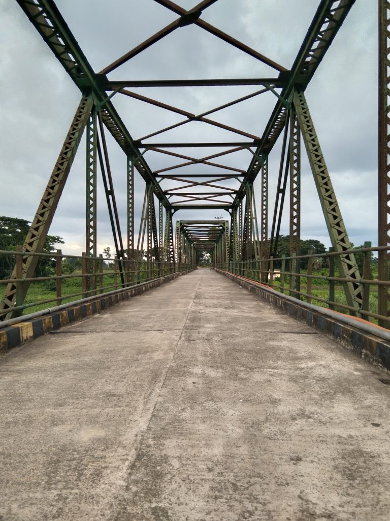 Bridge with concrete floor and steel girders above.