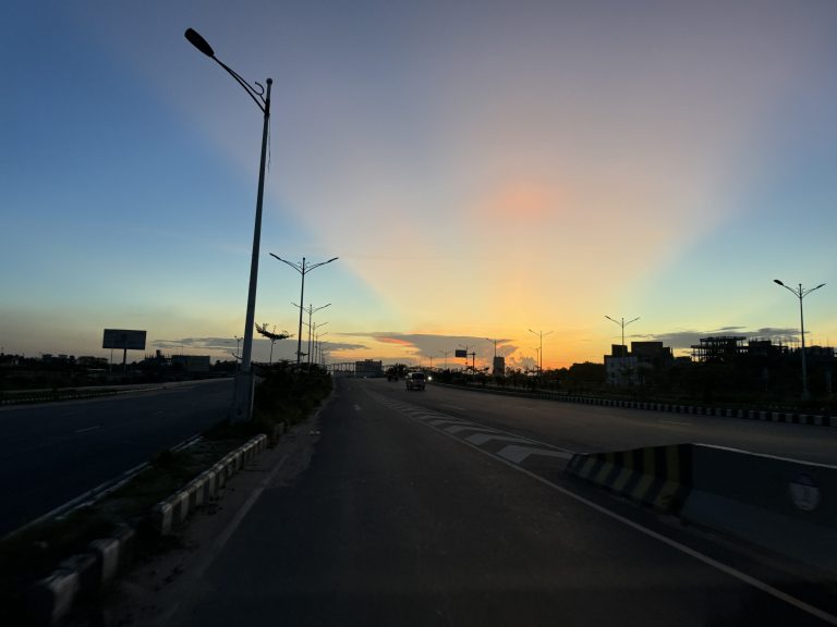 300 Feet Expressway Dhaka, Bangladesh. Sunrise and some cars on the road.