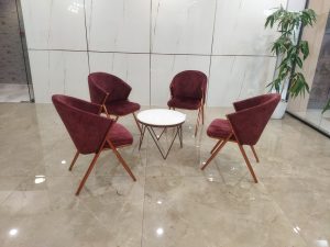 View larger photo: Contemporary office visitor area with a central table and surrounding chairs, offering a welcoming space for meetings and conversations.