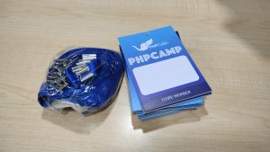 Attendee card and lanyard neatly placed on the table, welcoming guests to an exciting experience at PHP Camp 2024.