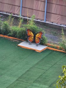 Butterfly statue in a garden area