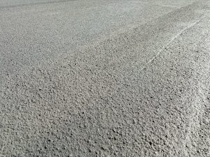 Closeup photo of freshly laid black asphalt on a road.