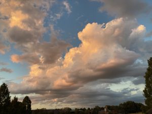 Some expressive clouds lit by a sunset with a low horizon.