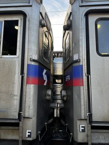 View larger photo: Looking up at two SEPTA regional rail train cars connected. You can see the sky behind it.