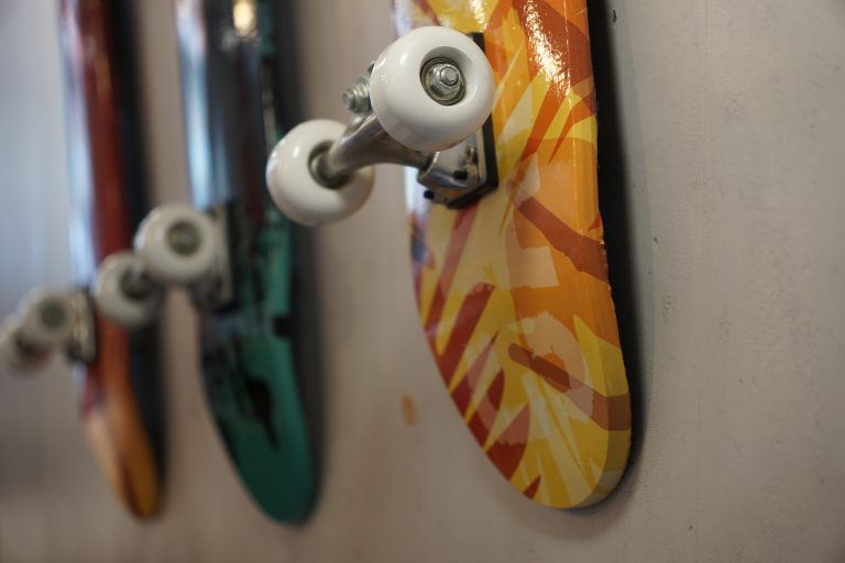 Colorful skateboards with with wheels hanging from a wall