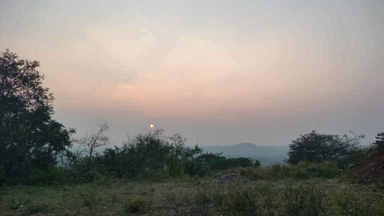 Sunset from hill station behind bush